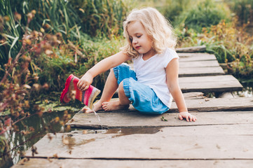 happy little girl on a wooden bridge