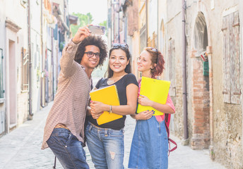Groups of friends are taking a selfie outdoors with their smartphone - multiethnic people - people,...