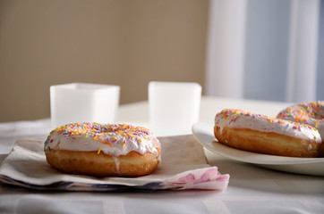donuts and dishes on the table. horizontal