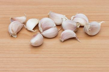 Garlic on brown wooden table.