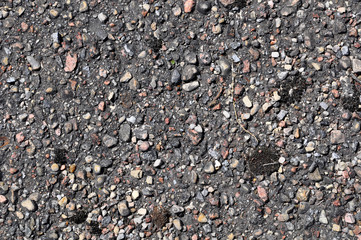 Old asphalt road with big grain stones background