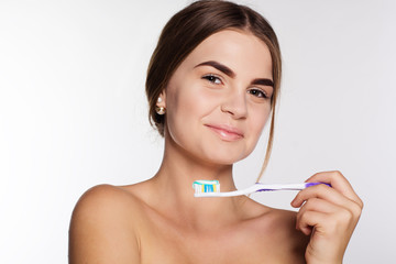 Teen girl is holding teeth brush with toothpaste