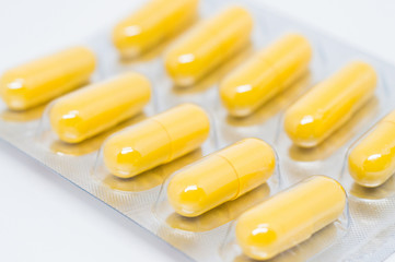 yellow pills in blister pack closeup selective focus