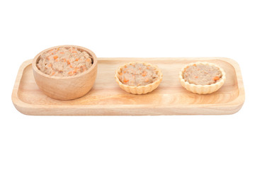 Homemade mini of tuna spread topping in wooden tray on white bac