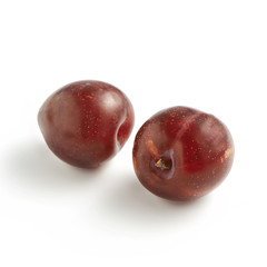 Pair of Red Plums on White Background