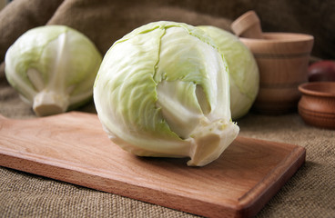 cabbage on a wooden board on a background sacking, burlap