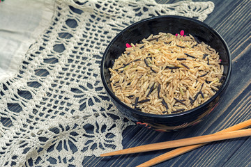 Unpolished rice on wooden background