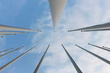 group of flagpoles and sky background