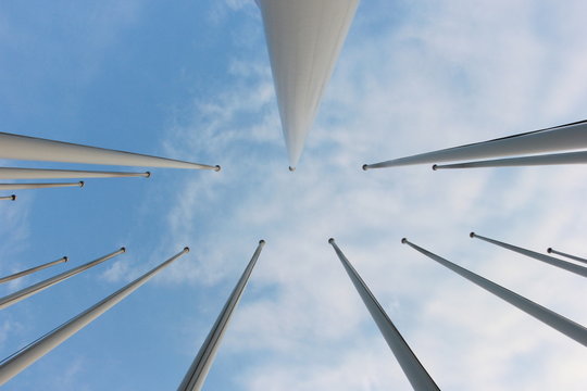 group of flagpoles and sky background