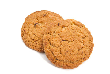 Two oatmeal cookies on white