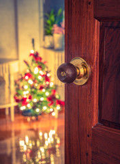 Open door and  Christmas tree in room ( Filtered image processed