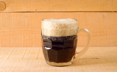 dark beer on wooden background