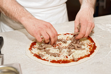 Making of a meat pizza