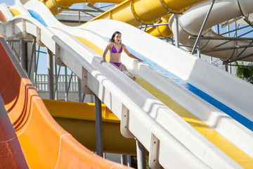 girl in bikini sliding water park