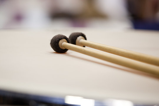 Drumsticks lying on timpani closeup