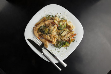 Chicken with vegetables in a white plate