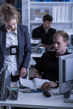 Police woman reviewing files