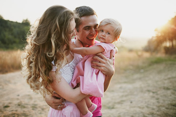 beautiful family of three people, mom dad and daughter