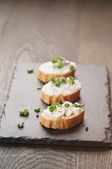 crunchy baguette slices with cream cheese and green onion