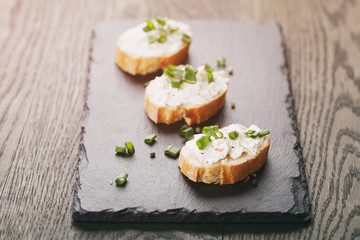 crunchy baguette slices with cream cheese and green onion