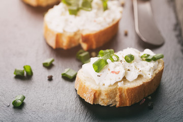 crunchy baguette slices with cream cheese and green onion