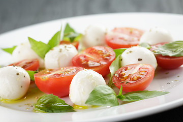 caprese salad with mini mozzarella balls and tomatoes