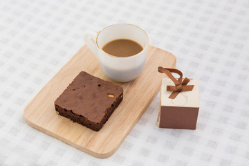 A cup of coffee with brownie cake