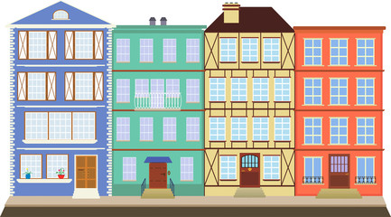 Four colored houses on the old street / Four houses like books on a shelf, are in the historic city