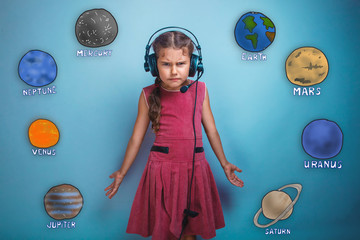 Teenage girl in headphones surprised furrowed face of the planet