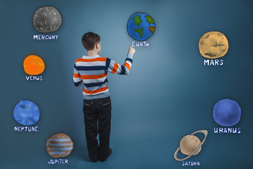 teenager boy turned his back and wrote a planet of the solar sys
