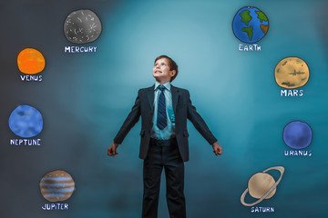 youth teenager boy simulates flight in a tie and laughing with h