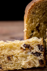 chocolate panettone sliced on wood traditional dessert for christmas in Italy