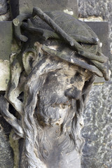 Fototapeta na wymiar Historic Jesus on the autumn mystery old Prague Cemetery, Czech Republic