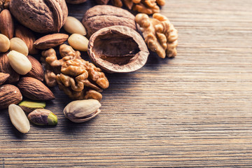 Almonds, walnuts and hazelnuts on wooden table. Various kinds of nuts
