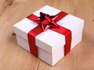 New Year gift on a golden tinsel background boly