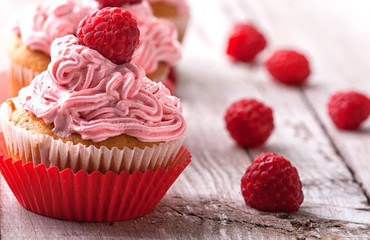 cupcake with cream and raspberry