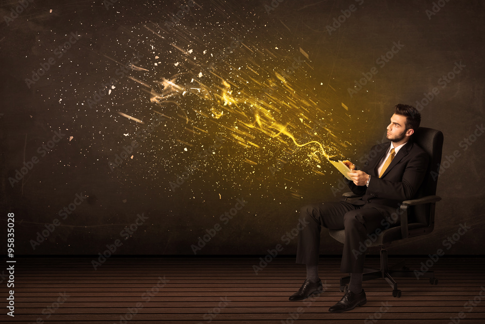 Poster Businessman with tablet and energy explosion on background