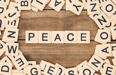 Peace spelled out in tan tile letters