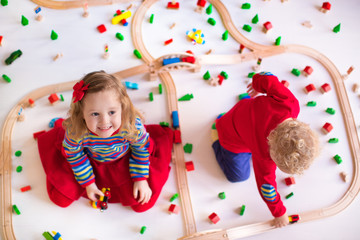Kids playing with wooden train set