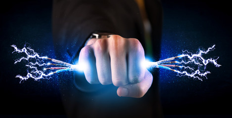 Business person holding electrical powered wires