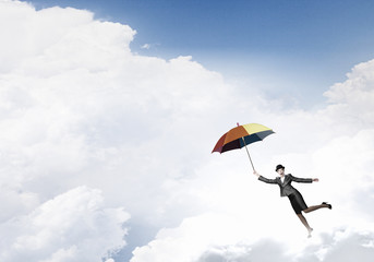 Woman flying on umbrella