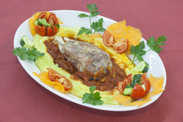 pork shank on a bed of polenta amatriciana