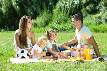Family of four having picnic