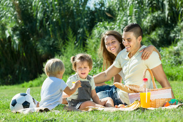 Family of four having picnic