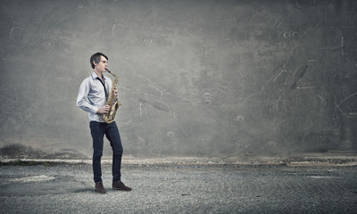 Handsome saxophonist. Concept image
