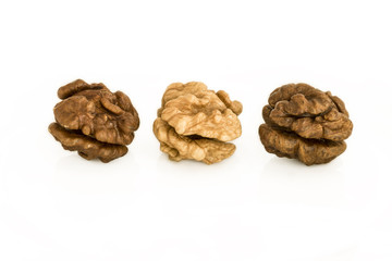 Walnuts. Three whole walnuts on a white background. The dark-light-dark peeled whole kernel.