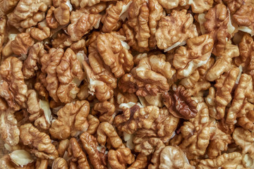Walnuts. Background of peeled bright walnut kernels.