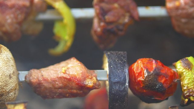 Pork, mushroom and slice of eggplant, meat is baked and turns on skewers kebabs, barbeque, brazier