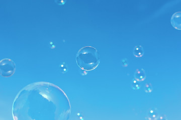  bubbles against the blue sky with clouds