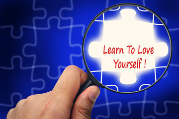 Learn To Love Yourself word. Magnifier and puzzles.